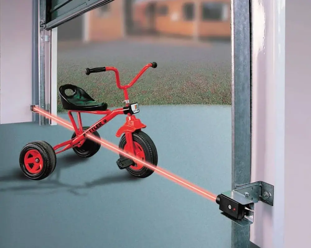 Garage door safety sensor laser beam alignment
